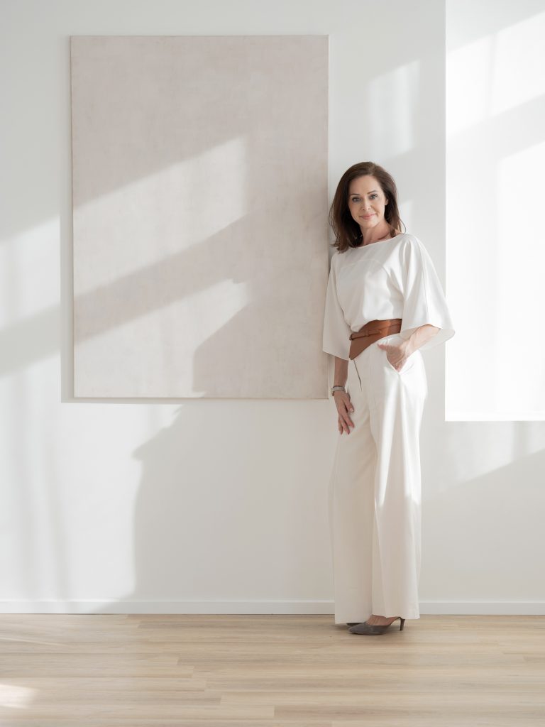 Kobieta w jasnym wnętrzu, naturalny portret biznesowy w minimalistycznym stylu